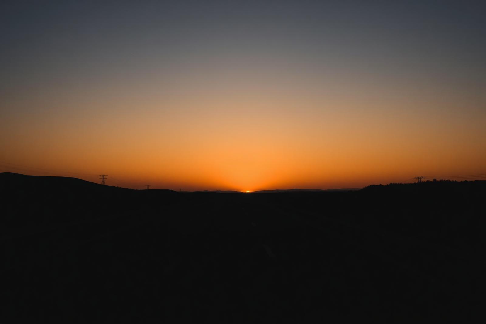 Open road stretching towards a warm horizon at first light